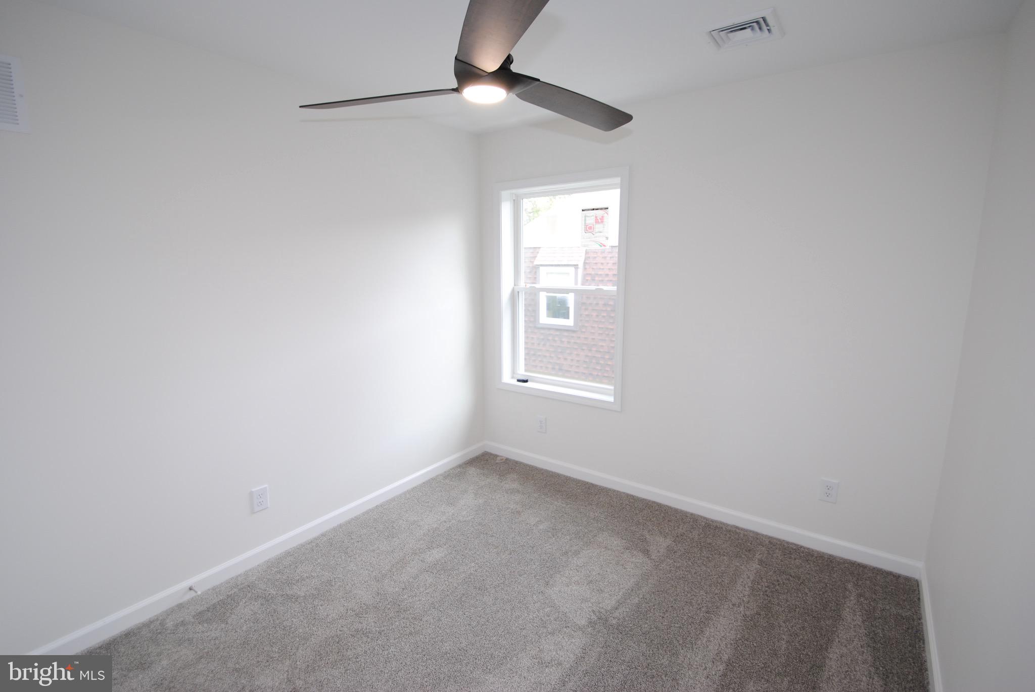 119-121 West 3rd Street Moorestown, NJ 08057 - Photo 18 of 25 an empty room with a window and ceiling fan