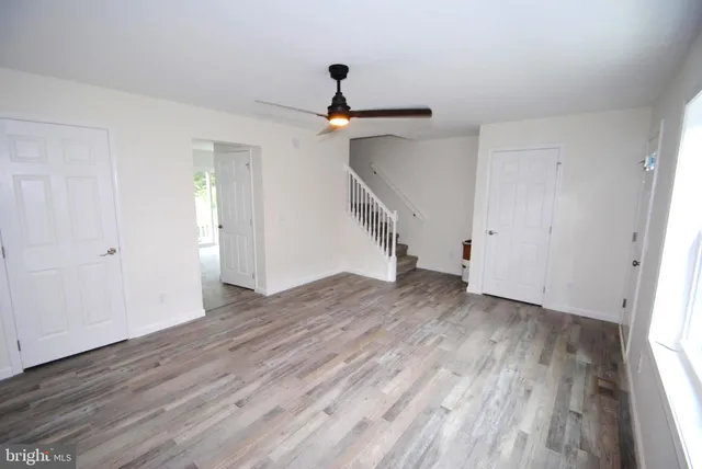 wooden floor in an empty room with a window