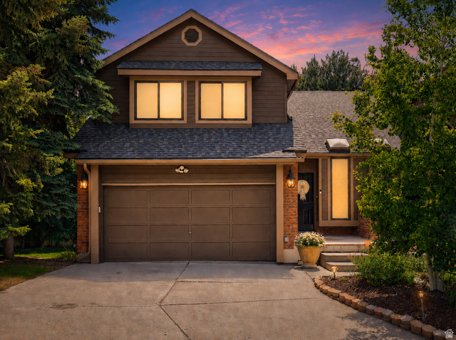 Front exterior featuring brown siding and brick accents