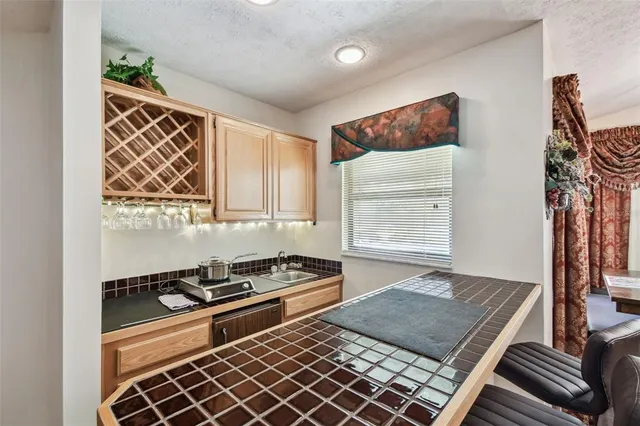 a kitchen with stainless steel appliances granite countertop a sink and a stove
