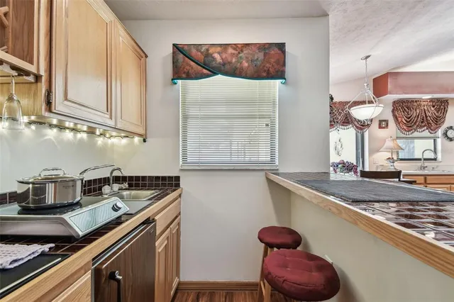 a view of a workspace with furniture and wooden floor