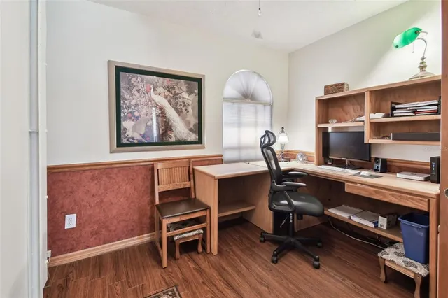 a view of a workspace with furniture and a window