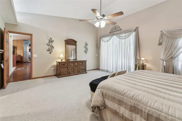 a spacious bathroom with a tub a sink and a painting on the wall
