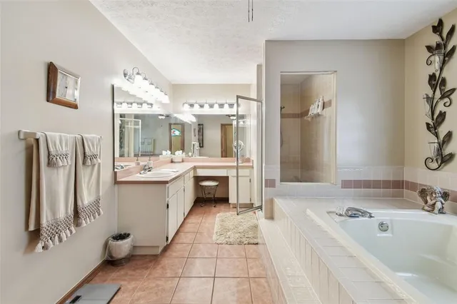 a view of a room that has a bed and wooden floor