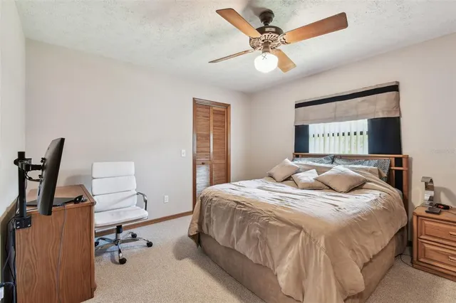 a bedroom with a bed and a television