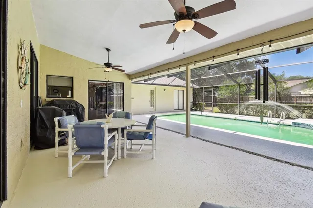 a view of a backyard with table and chairs under an umbrella