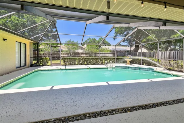 a view of a yard with a fence and trees