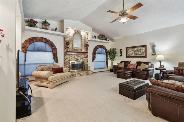 a living room with furniture a fireplace and white walls