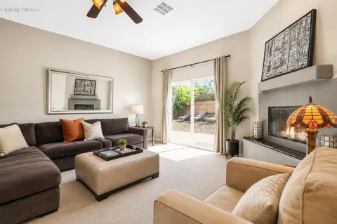 a living room with furniture kitchen and a chandelier