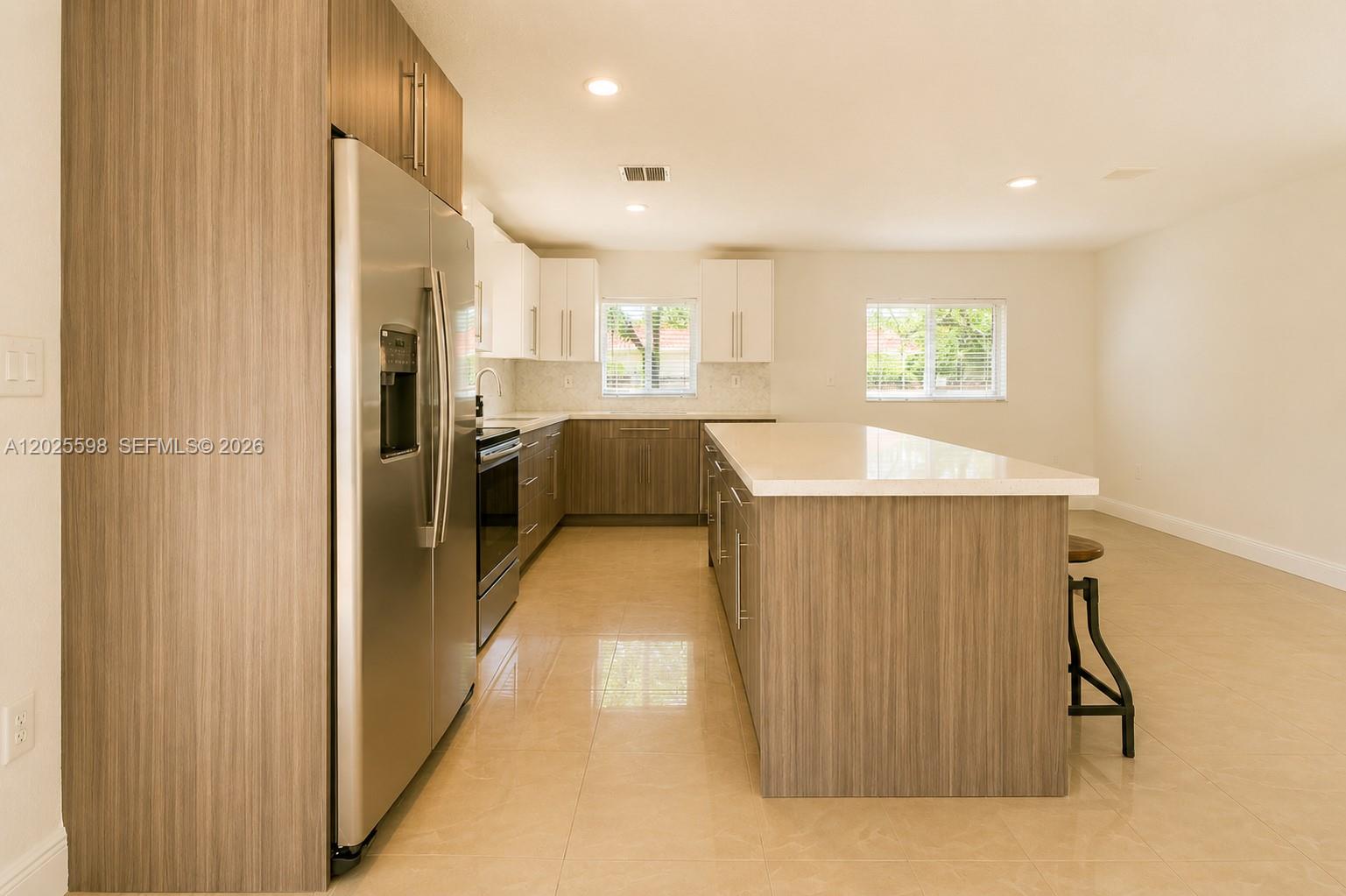 9421 Southwest 150th Street Miami, FL 33176 - Photo 12 of 31 a view of a kitchen with a refrigerator and a window