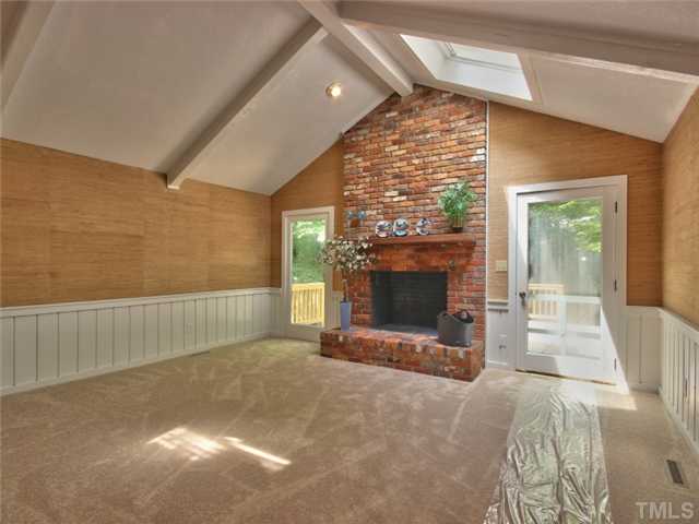 2701 Smokey Ridge Road Raleigh, NC 27613 - Photo 4 of 25 The family room has a vaulted ceiling, masonry fireplace door leading to the massive deck and two skylights. All freshly painted and new carpeting.