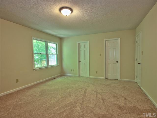 2701 Smokey Ridge Road Raleigh, NC 27613 - Photo 10 of 25 Master bedroom has new carpet, walk in closet and a double closet.