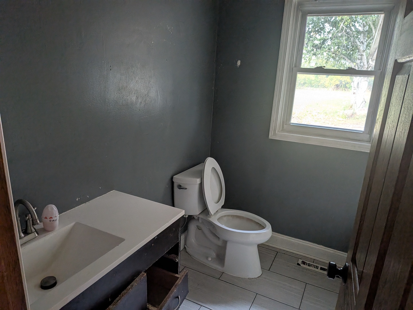 1718 Lincoln Road McHenry, IL 60051 - Photo 4 of 16 a bathroom with a toilet a sink and a window