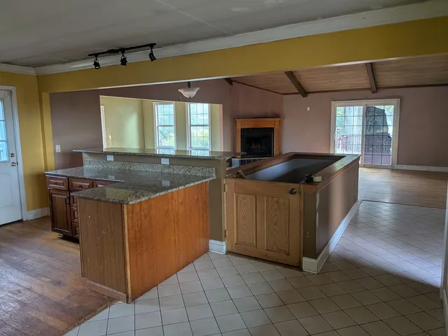 a kitchen with granite countertop a sink and a stove