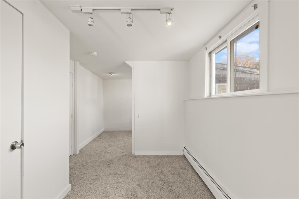 22 Taylor Street, Unit 1 Gloucester, MA 01930 - Photo 15 of 31 an empty room with windows and closet