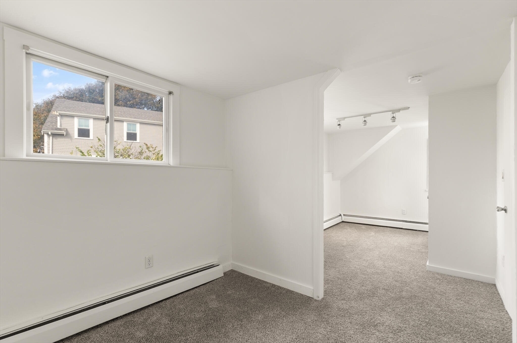 22 Taylor Street, Unit 1 Gloucester, MA 01930 - Photo 16 of 31 an empty room with a window