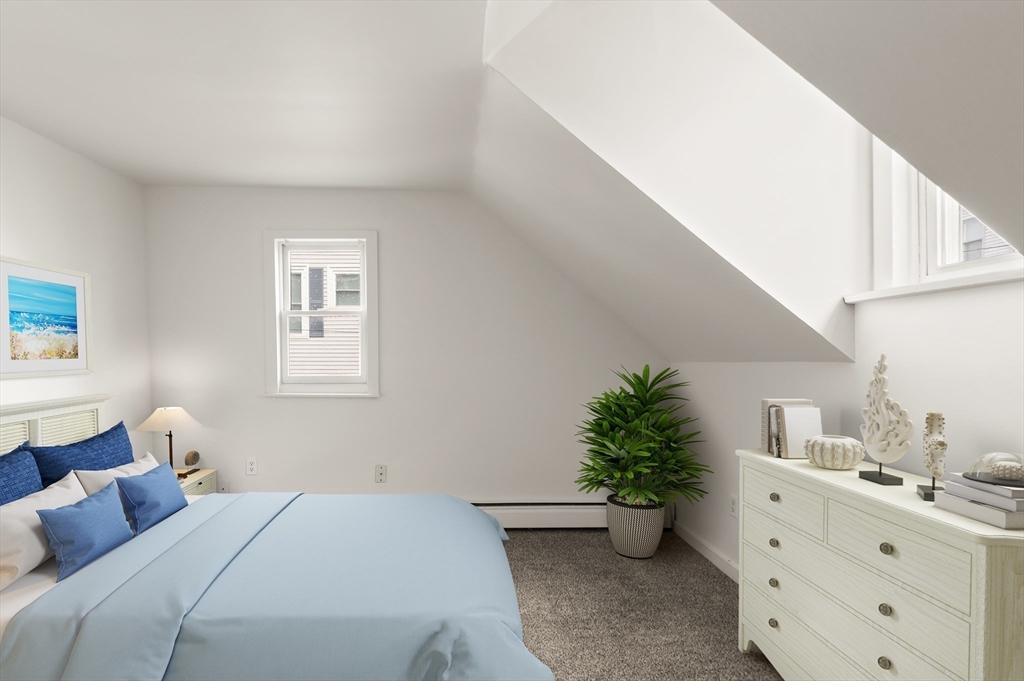 22 Taylor Street, Unit 1 Gloucester, MA 01930 - Photo 18 of 31 a bedroom with a bed and a potted plant