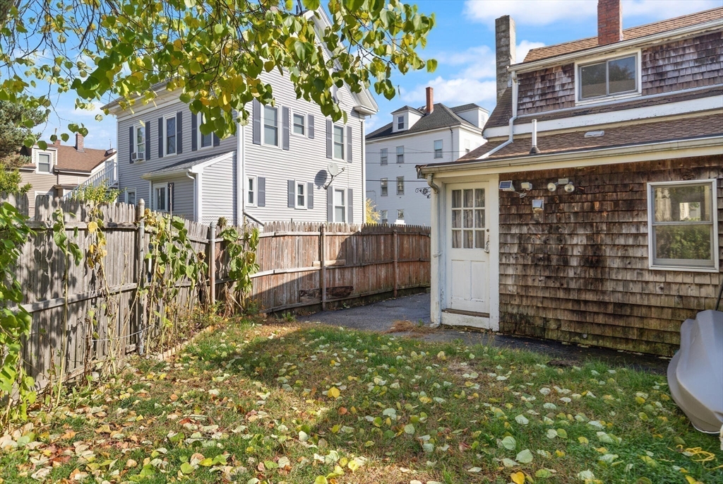 22 Taylor Street, Unit 1 Gloucester, MA 01930 - Photo 22 of 31 a view of a house with a yard and wooden fence
