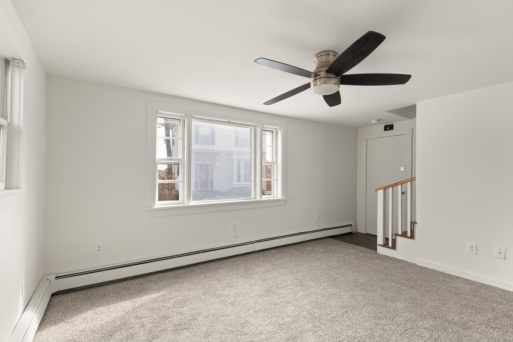 22 Taylor Street, Unit 1 Gloucester, MA 01930 - Photo 5 of 31 a view of a livingroom with a ceiling fan and window