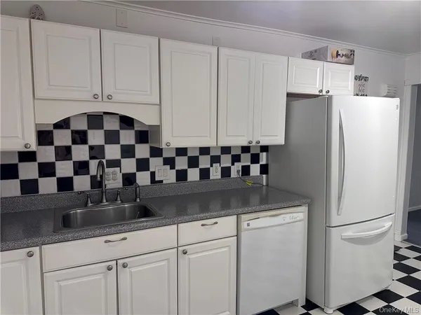 a kitchen with refrigerator and cabinets