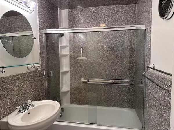 a bathroom with a sink a mirror and a shower