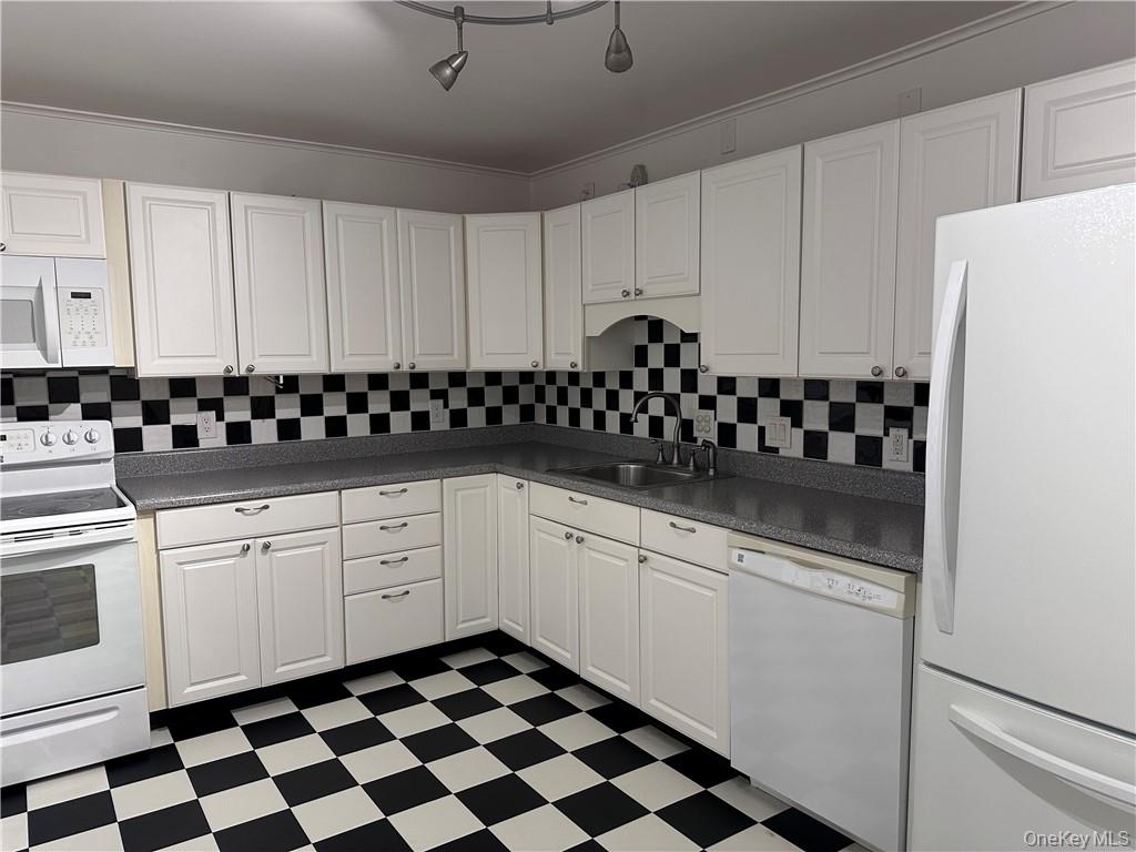 407 Old Mill Road Southfields, NY 10975 - Photo 10 of 29 a kitchen with granite countertop white cabinets and black appliances