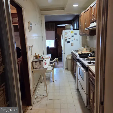 a kitchen with stainless steel appliances granite countertop a refrigerator and a stove