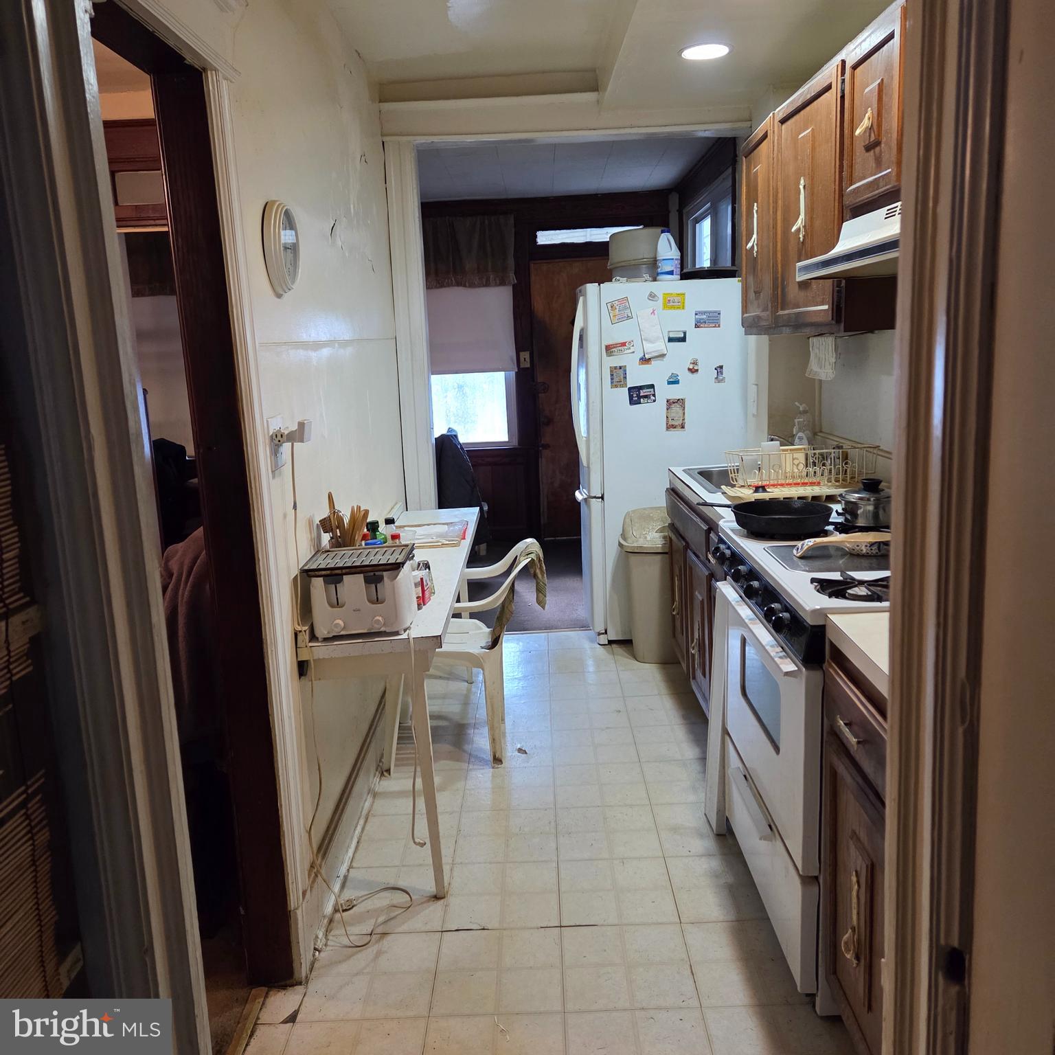 1269 Oates Street Northeast Washington, DC 20002 - Photo 4 of 13 a kitchen with stainless steel appliances granite countertop a refrigerator and a stove