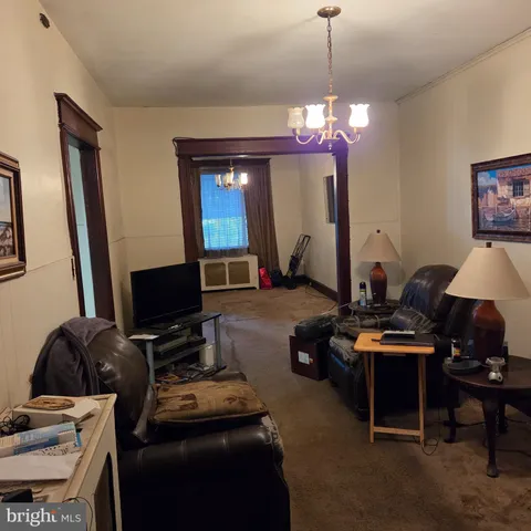 a room with furniture a flat screen tv and a window