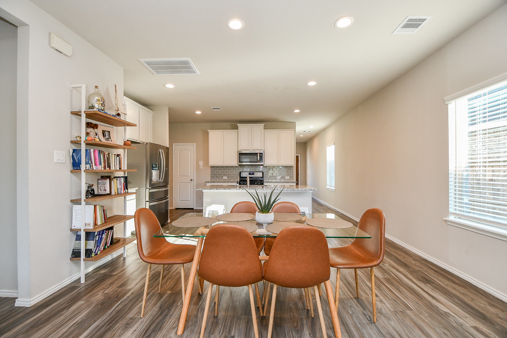 16868 Pink Wintergreen Drive Conroe, TX 77385 - Photo 12 of 32 a view of a dining room with furniture window and wooden floor