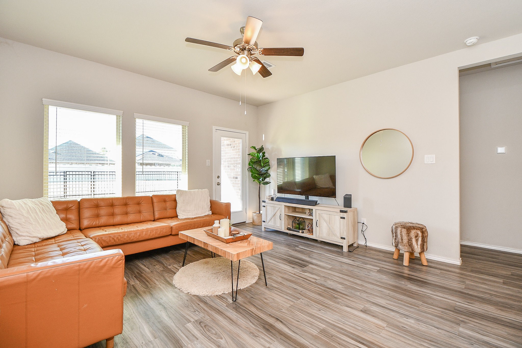 16868 Pink Wintergreen Drive Conroe, TX 77385 - Photo 13 of 32 a living room with furniture a flat screen tv and a large window