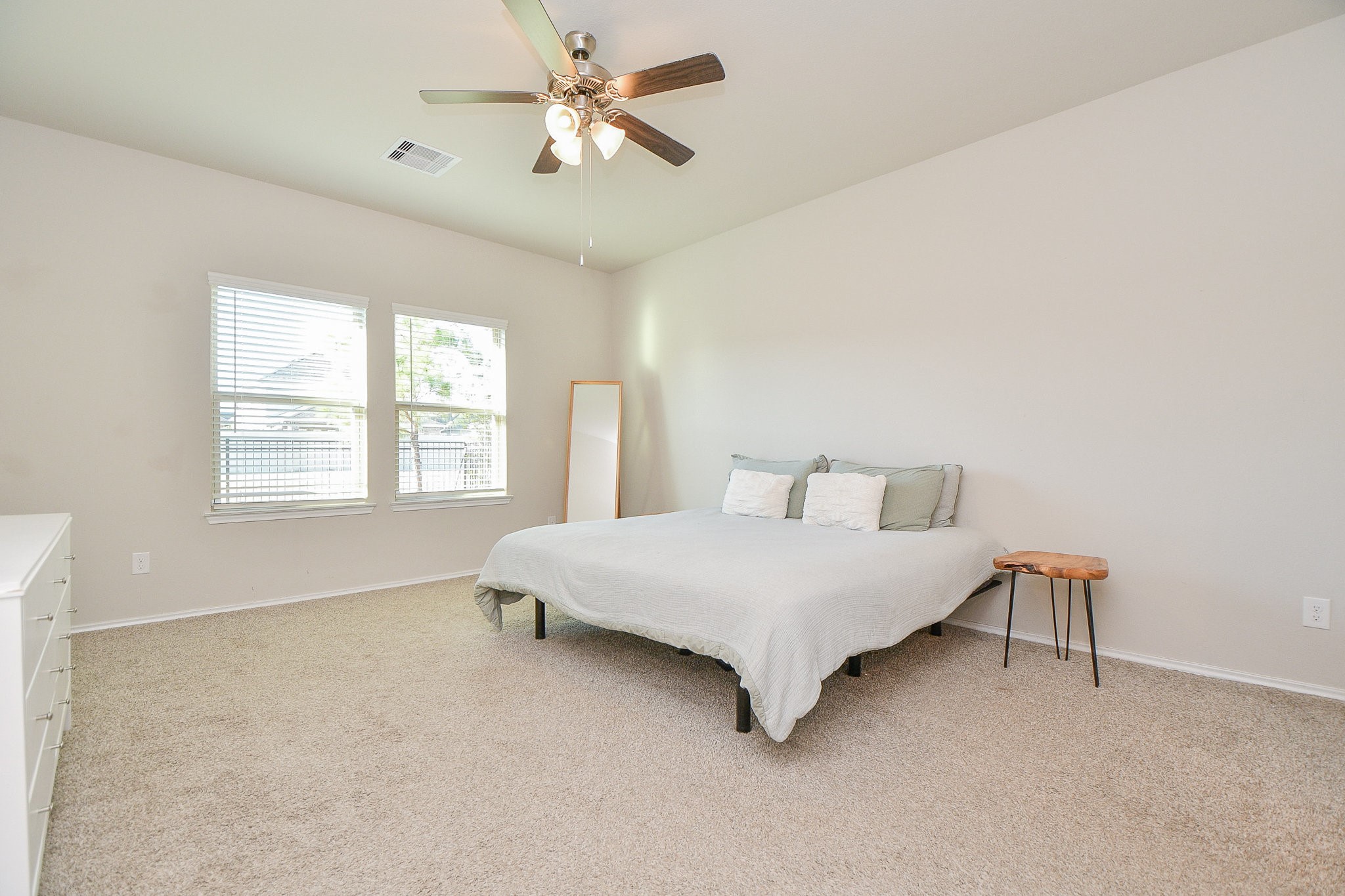 16868 Pink Wintergreen Drive Conroe, TX 77385 - Photo 15 of 32 a spacious bedroom with a bed dresser and a window
