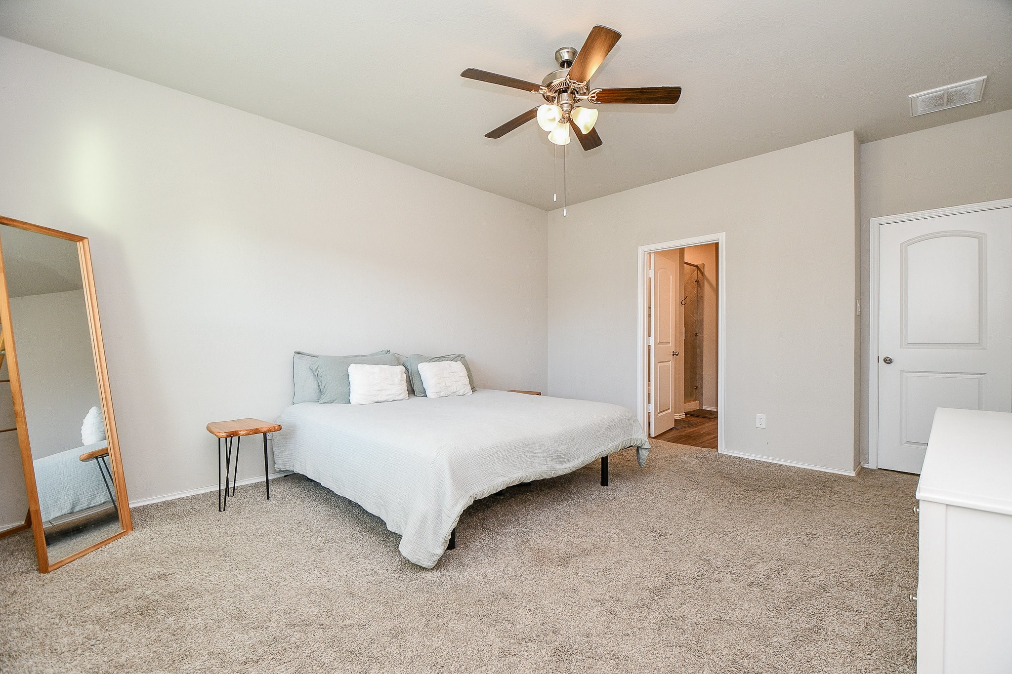 16868 Pink Wintergreen Drive Conroe, TX 77385 - Photo 17 of 32 a spacious bedroom with a bed and a chandelier