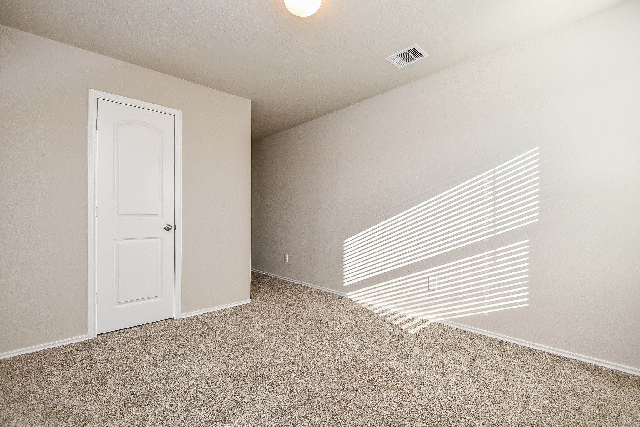 16868 Pink Wintergreen Drive Conroe, TX 77385 - Photo 21 of 32 a view of a room with a white wall and a window