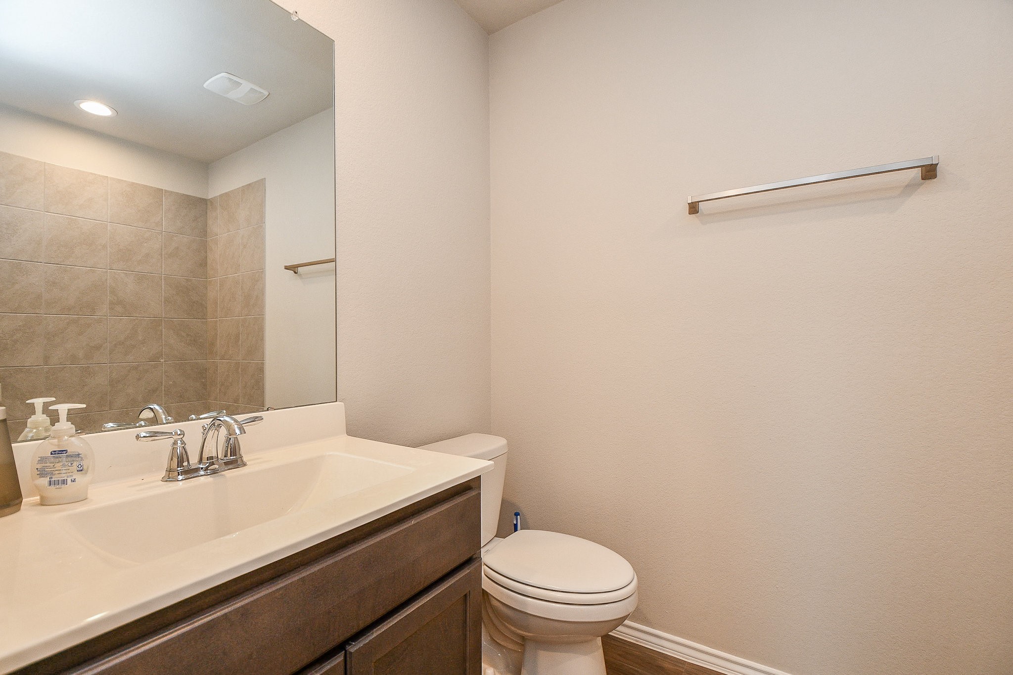 16868 Pink Wintergreen Drive Conroe, TX 77385 - Photo 24 of 32 a bathroom with a sink a toilet and a mirror