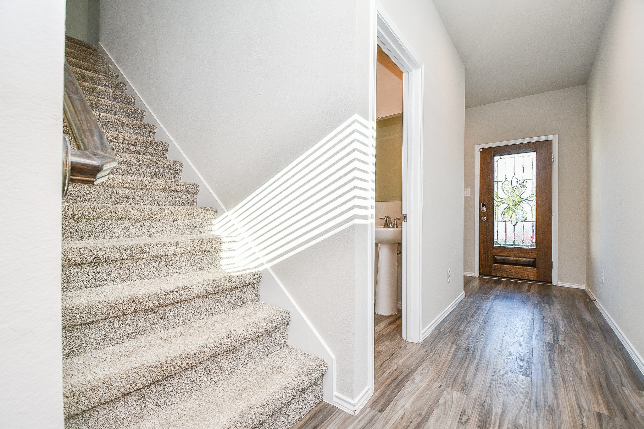 16868 Pink Wintergreen Drive Conroe, TX 77385 - Photo 3 of 32 a view of entryway with wooden floor and stairs