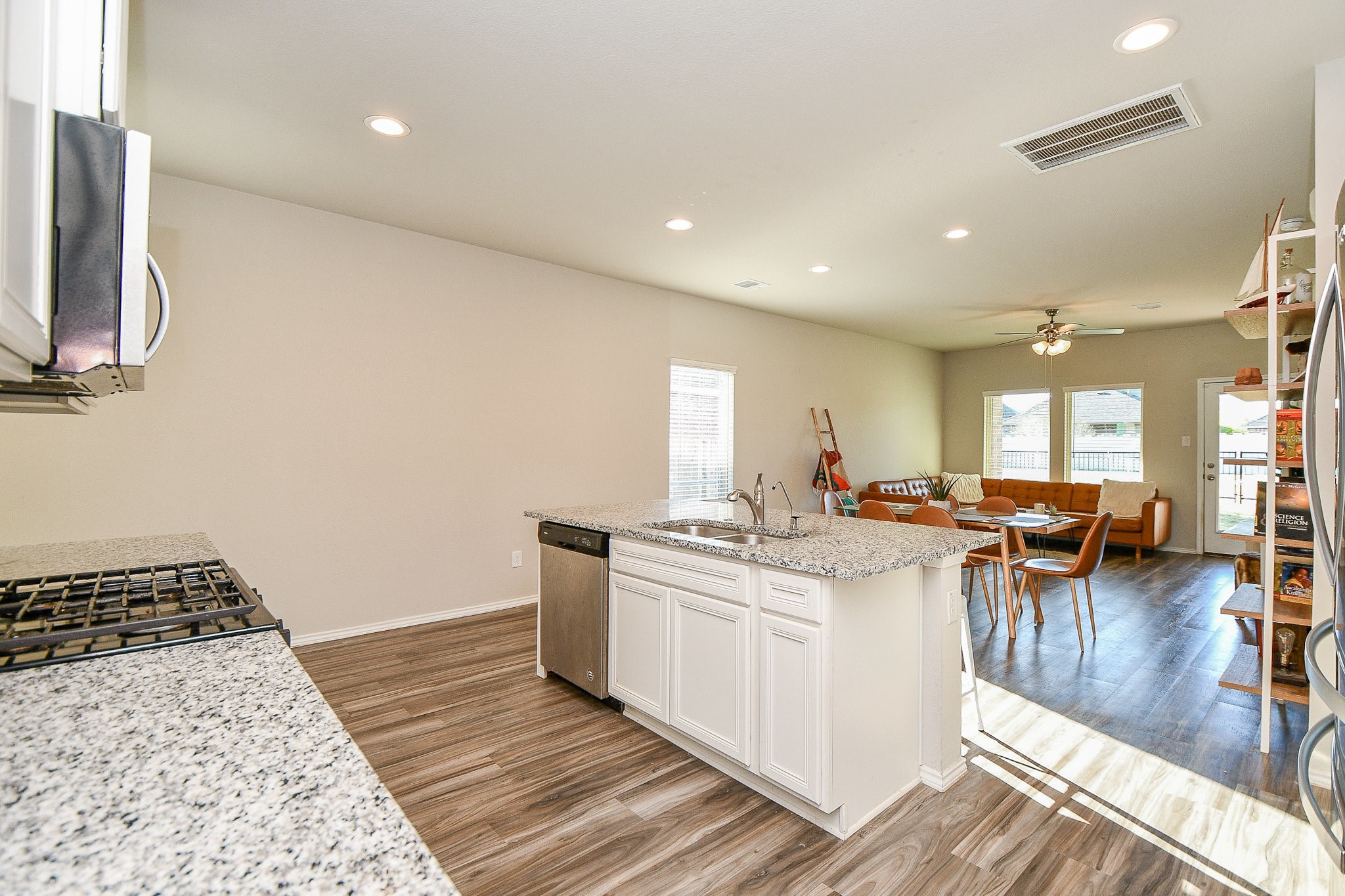 16868 Pink Wintergreen Drive Conroe, TX 77385 - Photo 6 of 32 a kitchen with stainless steel appliances granite countertop a sink stove and cabinets