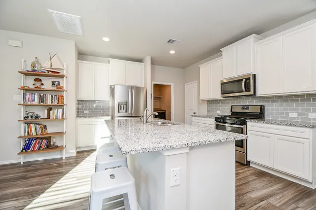 a dining room with furniture a large window and wooden floor