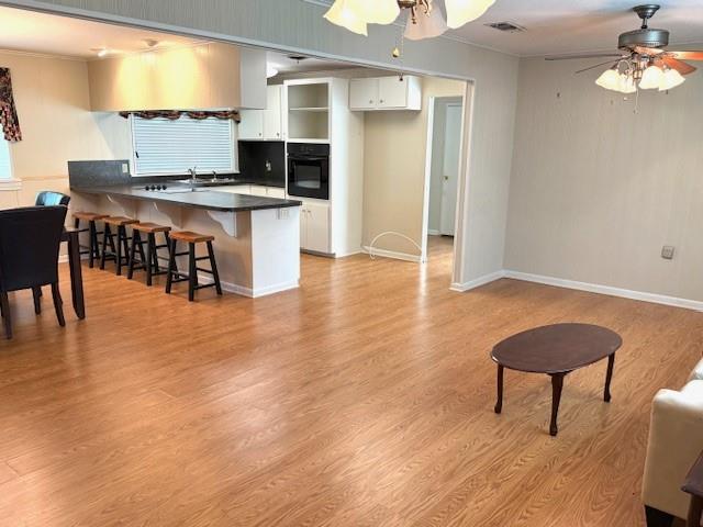 104 Oak Street Homer, LA 71040 - Photo 3 of 29 a kitchen with stainless steel appliances granite countertop a stove top oven a sink a dining table and chairs with wooden floor