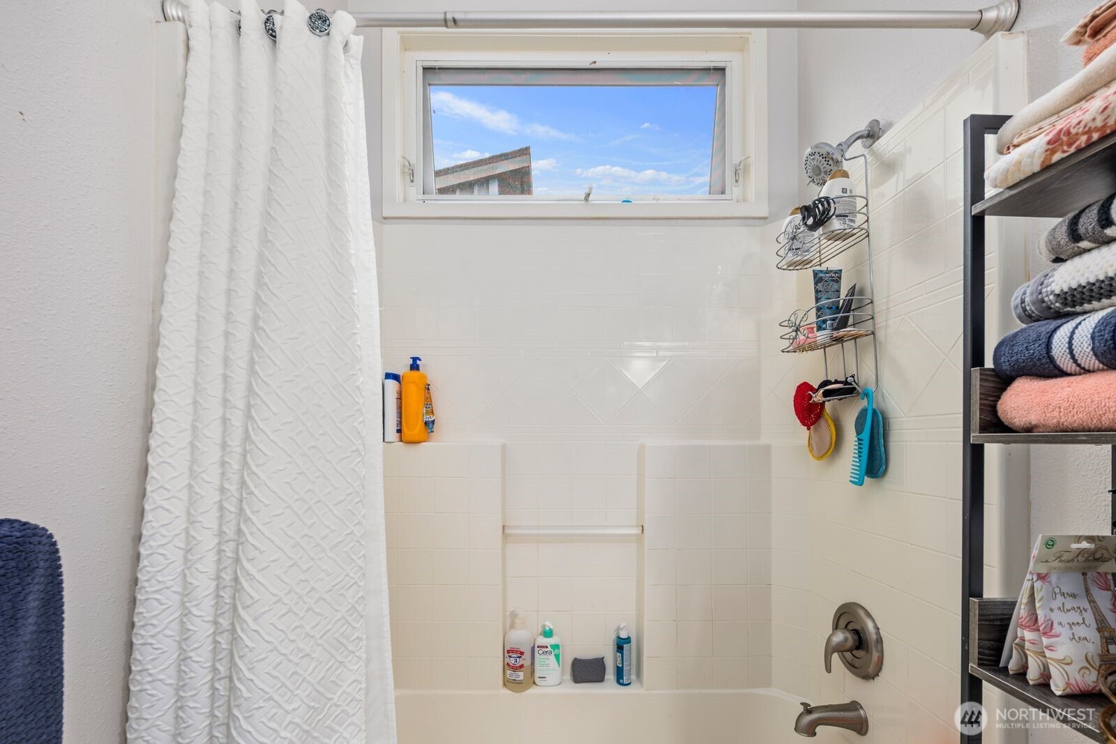 9452 25th Avenue Southwest Seattle, WA 98106 - Photo 20 of 37 a bathroom with a shower curtain and a sink
