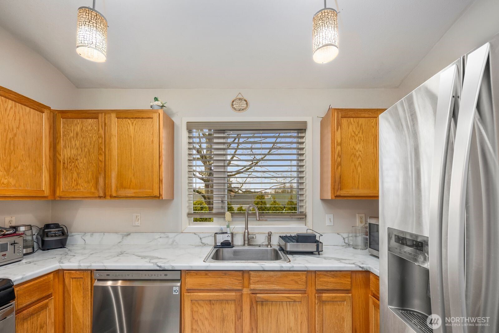 9452 25th Avenue Southwest Seattle, WA 98106 - Photo 29 of 37 a kitchen with sink a window and cabinets