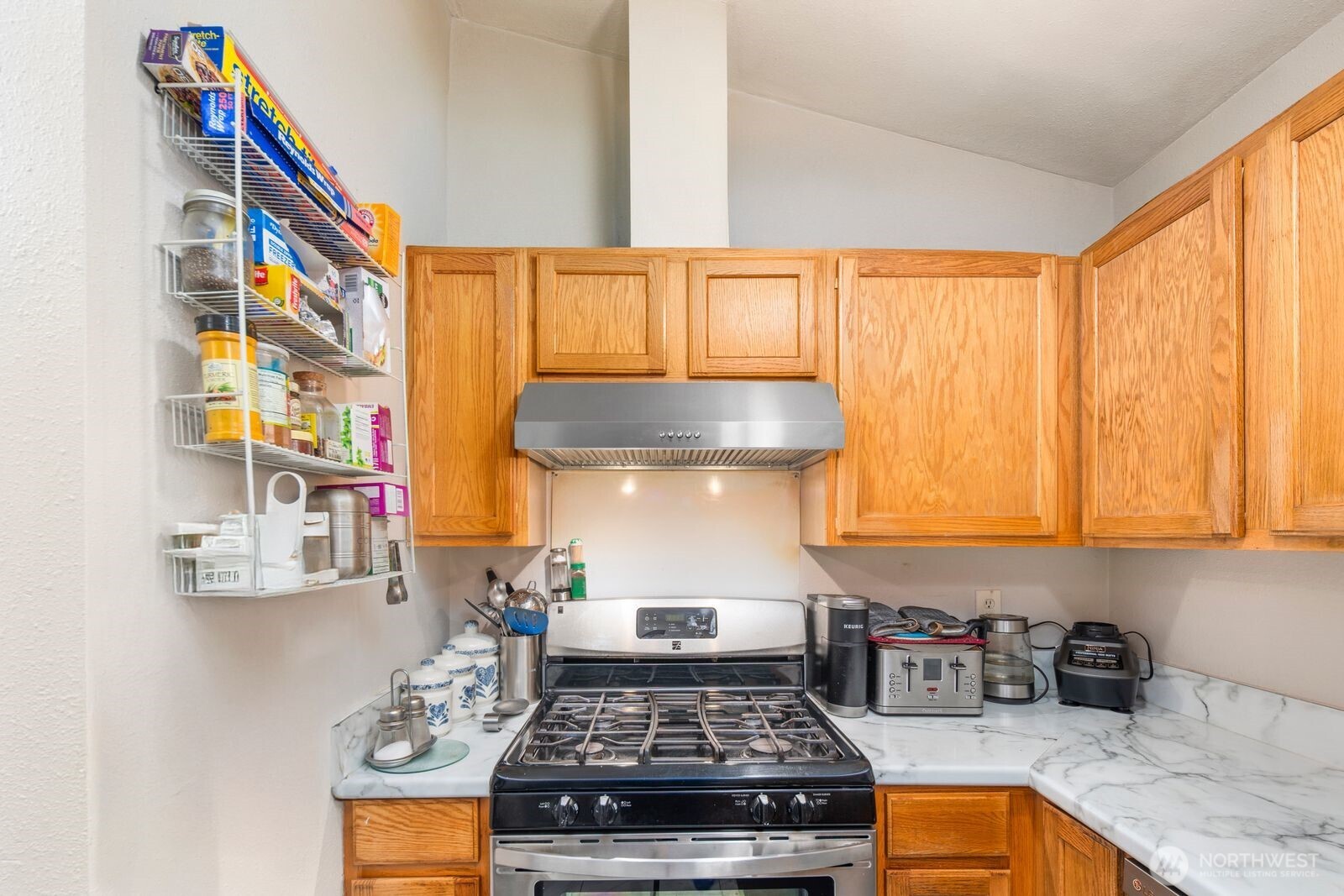 9452 25th Avenue Southwest Seattle, WA 98106 - Photo 31 of 37 a kitchen with stainless steel appliances granite countertop a stove a sink and a microwave