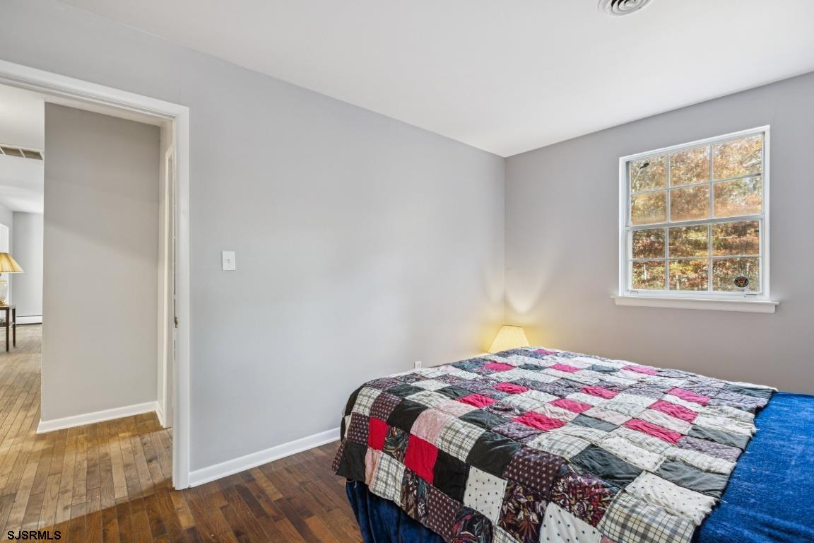207 Sooy Place Road Tabernacle, NJ 08088 - Photo 11 of 25 a bedroom with a bed and wooden floor