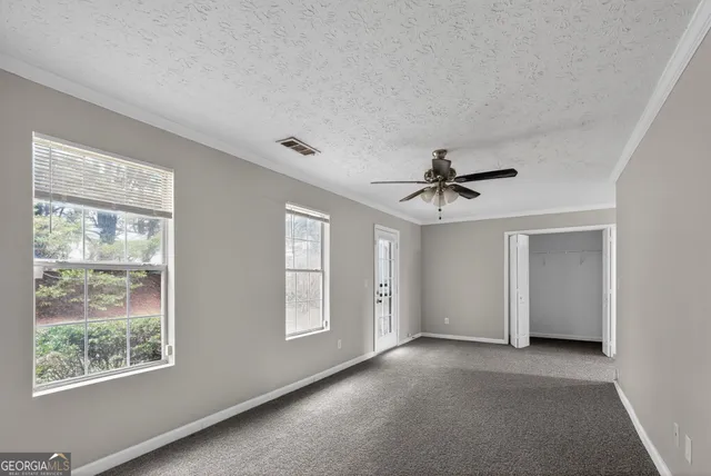 a view of a livingroom with a window and a ceiling fan
