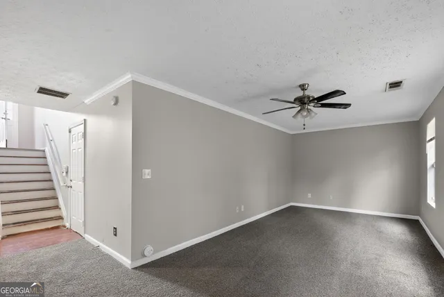 a view of a room with wooden floor and windows
