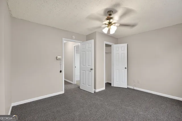 a view of a chandelier fan and entryway