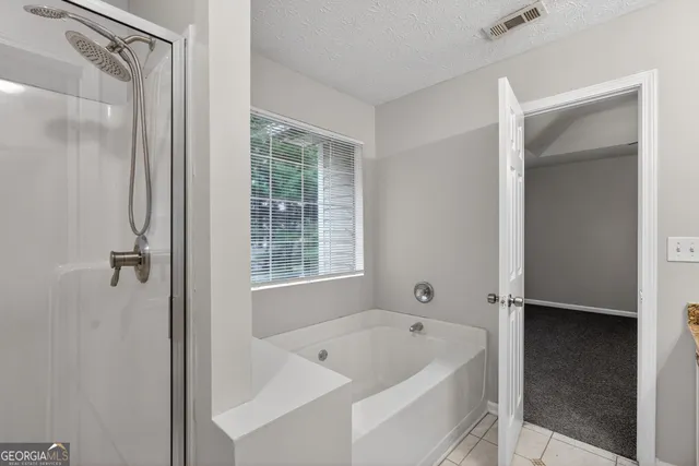 a white bath tub sitting next to a shower