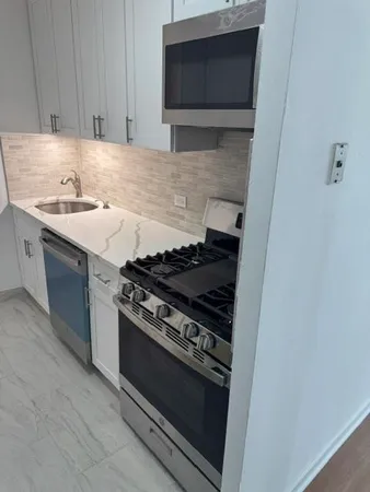 a white refrigerator freezer sitting in a kitchen