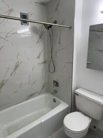 a bathroom with a sink toilet and mirror