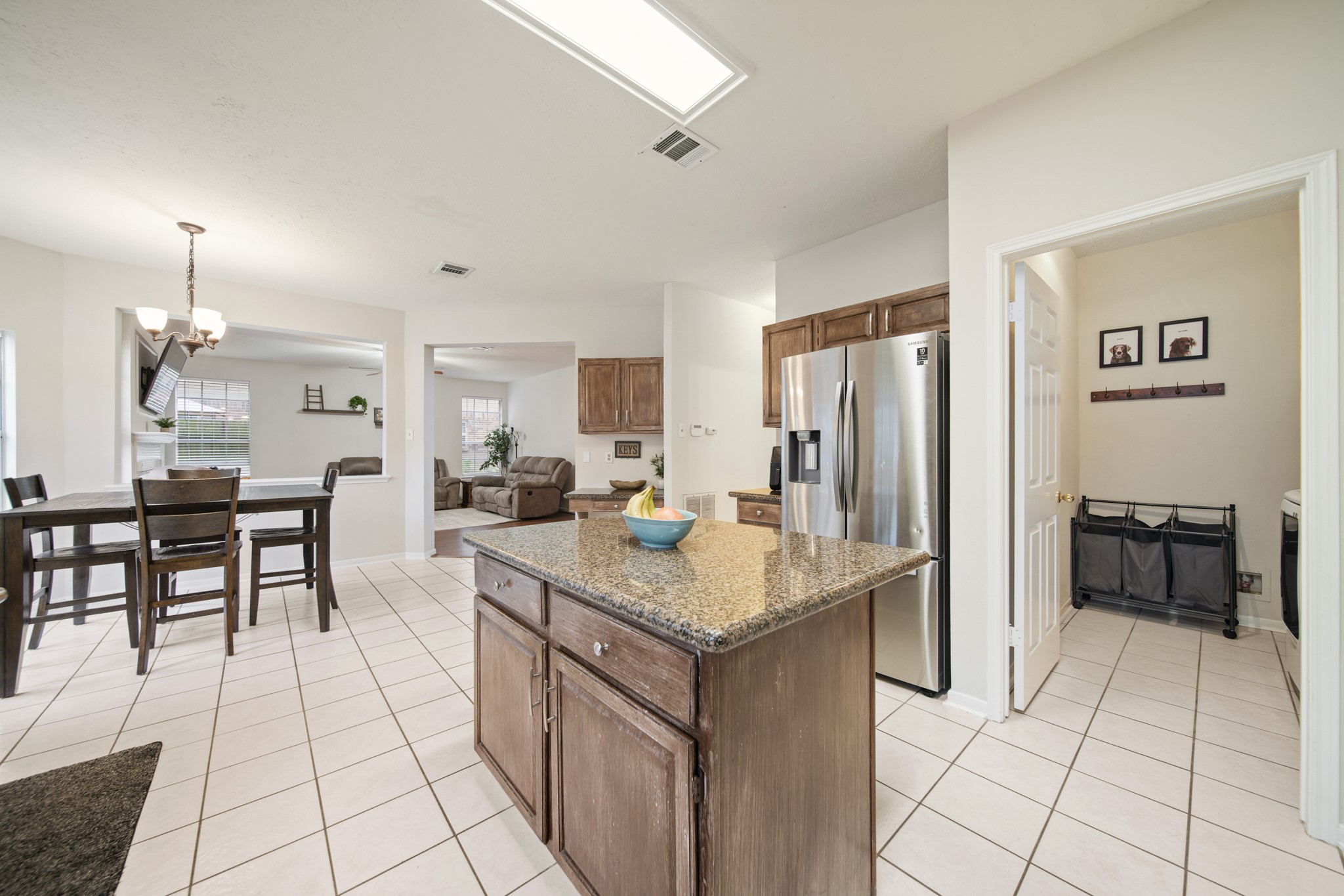 16114 Kintyre Point Road Houston, TX 77095 - Photo 24 of 41 a kitchen with kitchen island granite countertop a refrigerator a stove a sink and a dining table